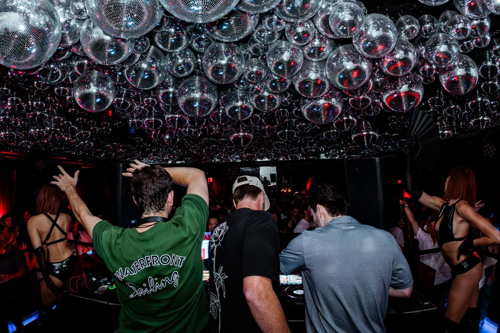 A crowd at the booth under the disco balls